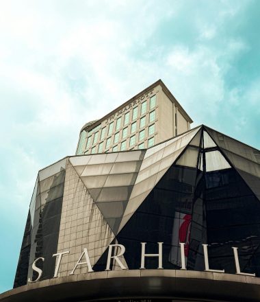 Striking architectural design of the Starhill building in vibrant daylight.